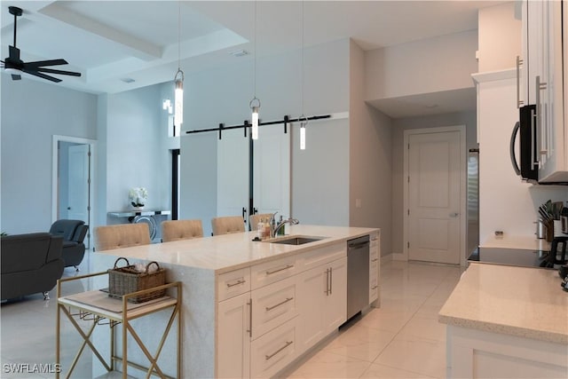 kitchen with stainless steel appliances, a sink, pendant lighting, ceiling fan, and white cabinets