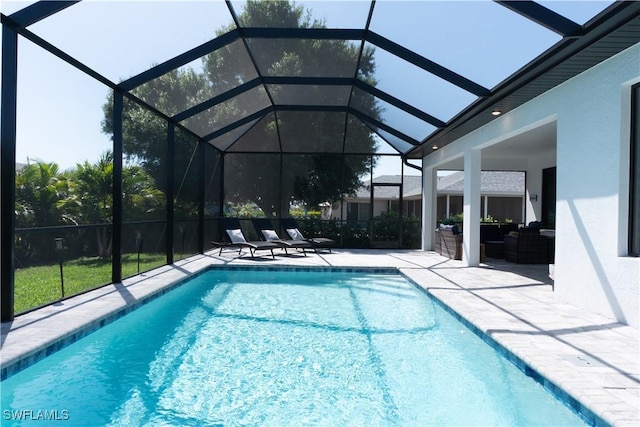 outdoor pool with a patio and a lanai