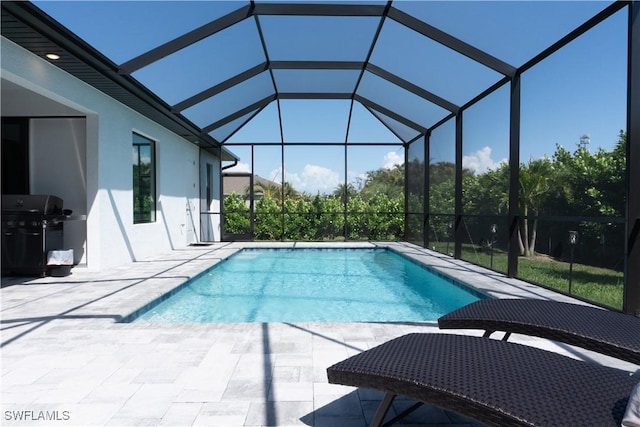 outdoor pool featuring a lanai, a grill, and a patio