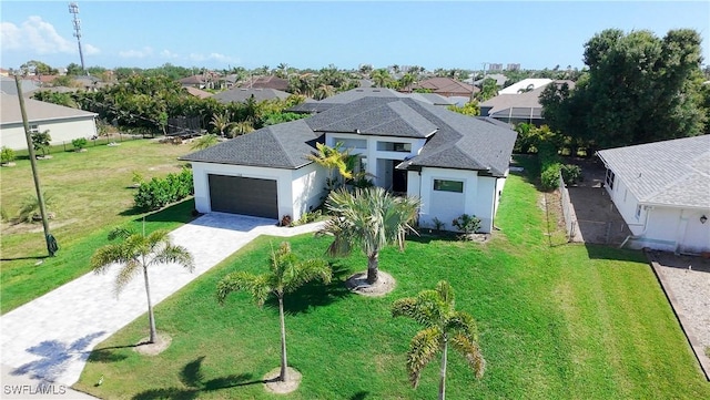 view of front of property with a front yard, stucco siding, a residential view, decorative driveway, and a garage