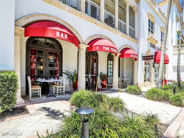 365 5th Ave S Unit 307, Naples, FL 34102 - view of exterior entry featuring french doors and stucco siding