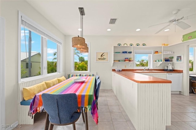 984 Black Skimmer Way, Sanibel, FL 33957 - kitchen featuring open shelves, white cabinetry, a peninsula, white dishwasher, and visible vents