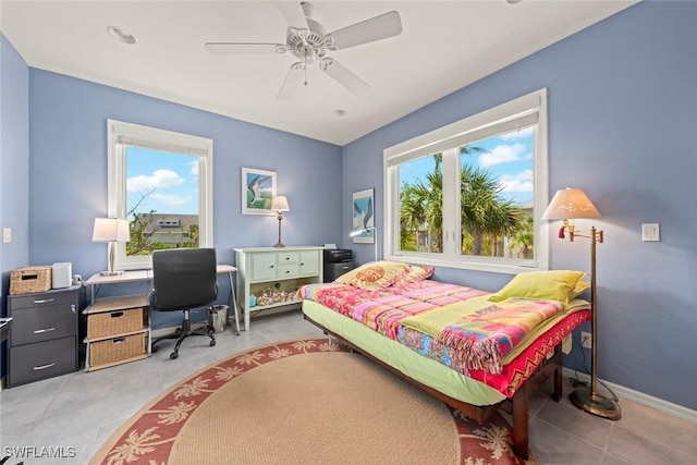 984 Black Skimmer Way, Sanibel, FL 33957 - bedroom featuring light tile patterned floors, baseboards, multiple windows, and ceiling fan