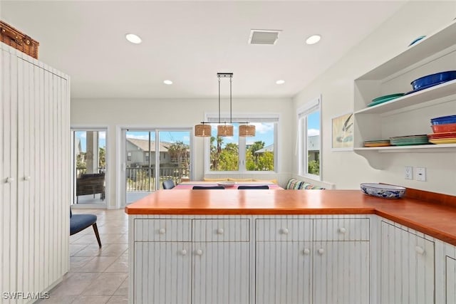 984 Black Skimmer Way, Sanibel, FL 33957 - kitchen featuring visible vents, a peninsula, recessed lighting, open shelves, and light tile patterned floors