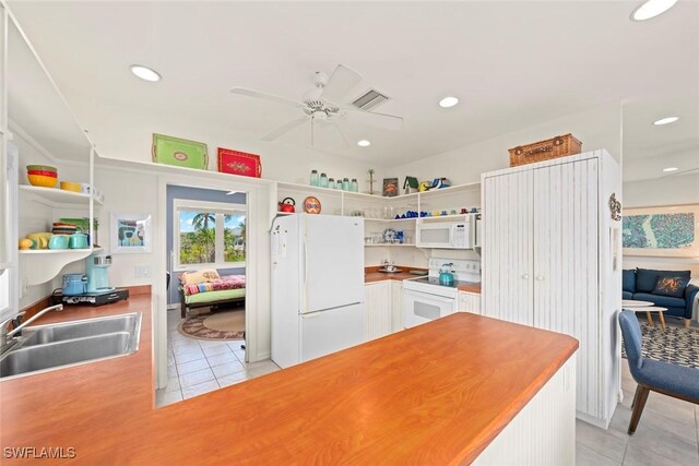 984 Black Skimmer Way, Sanibel, FL 33957 - kitchen featuring open shelves, white appliances, light tile patterned floors, a sink, and ceiling fan