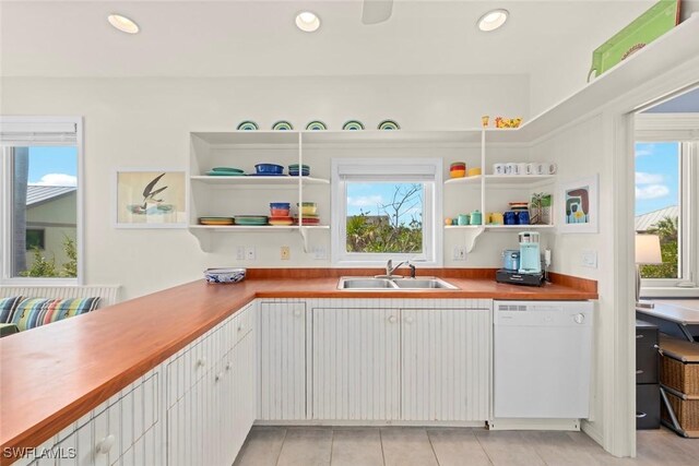 984 Black Skimmer Way, Sanibel, FL 33957 - kitchen with recessed lighting, a sink, open shelves, white dishwasher, and light tile patterned floors
