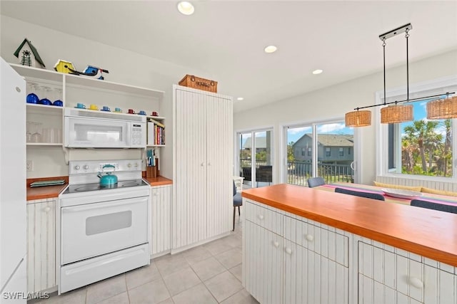 984 Black Skimmer Way, Sanibel, FL 33957 - kitchen with light countertops, light tile patterned flooring, recessed lighting, and white appliances