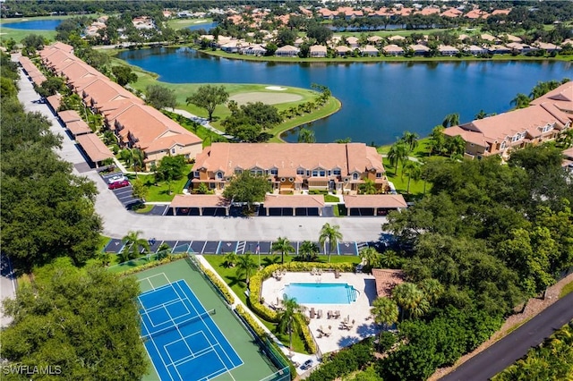 aerial view of residential area with a nearby body of water and a pool