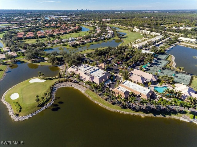 aerial view of property's location with nearby suburban area, a nearby body of water, and a local golf course