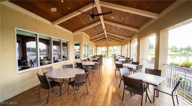 sunroom / solarium with a water view