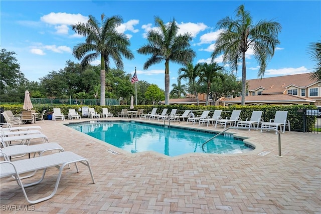 community pool featuring a patio area and fence