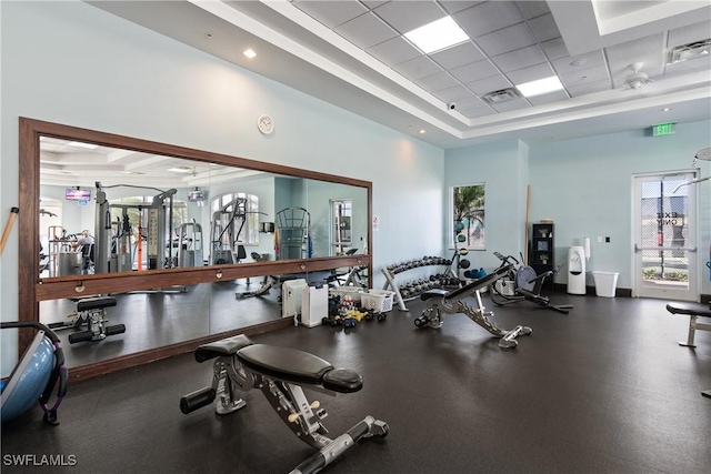 gym featuring a raised ceiling