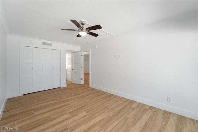 100 Estero Blvd Unit 633, Fort Myers Beach, FL 33931 - unfurnished bedroom with light wood-style floors, baseboards, a closet, and a ceiling fan
