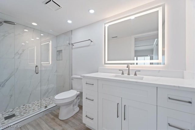 100 Estero Blvd Unit 633, Fort Myers Beach, FL 33931 - full bathroom featuring toilet, a marble finish shower, vanity, wood finished floors, and recessed lighting