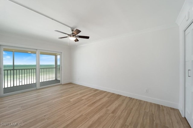 100 Estero Blvd Unit 633, Fort Myers Beach, FL 33931 - spare room with a ceiling fan, baseboards, light wood-type flooring, a water view, and ornamental molding