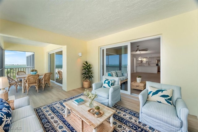 100 Estero Blvd Unit 633, Fort Myers Beach, FL 33931 - living room with light wood-style flooring and a textured ceiling