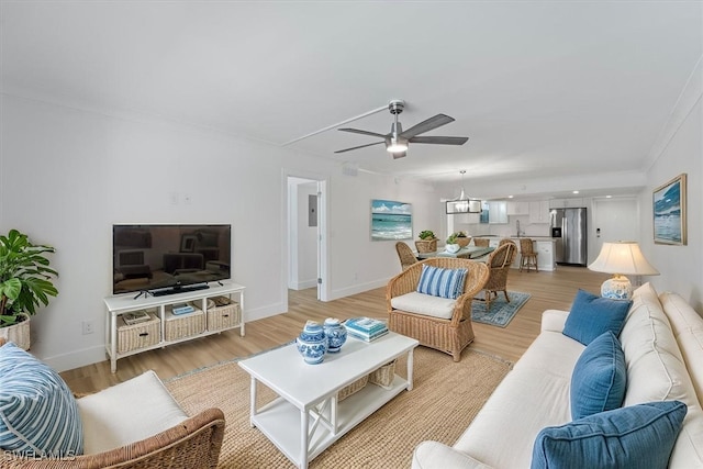 100 Estero Blvd Unit 633, Fort Myers Beach, FL 33931 - living room with a ceiling fan, light wood finished floors, ornamental molding, and baseboards