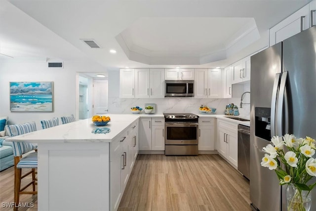 100 Estero Blvd Unit 633, Fort Myers Beach, FL 33931 - kitchen with stainless steel appliances, a sink, a peninsula, light wood-style floors, and recessed lighting