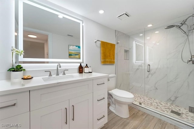 100 Estero Blvd Unit 633, Fort Myers Beach, FL 33931 - full bathroom featuring a marble finish shower, vanity, toilet, wood finished floors, and recessed lighting