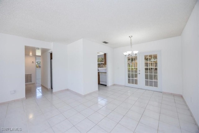 2590 Poinciana St, Naples, FL 34105 - spare room featuring visible vents, a textured ceiling, a notable chandelier, and light tile patterned flooring