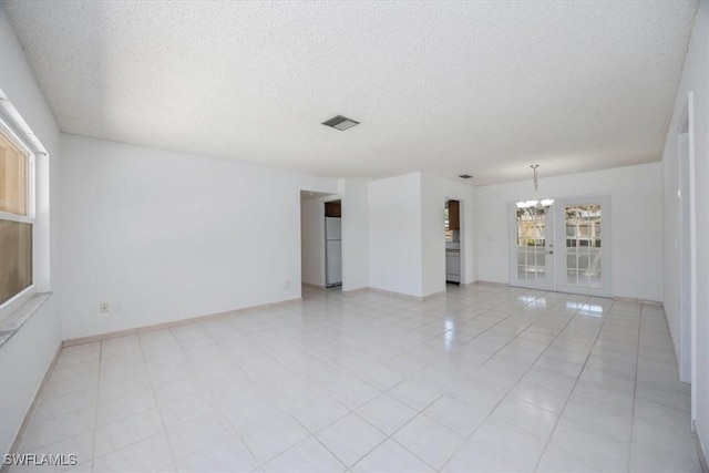 2590 Poinciana St, Naples, FL 34105 - unfurnished room with visible vents, baseboards, a chandelier, and a textured ceiling