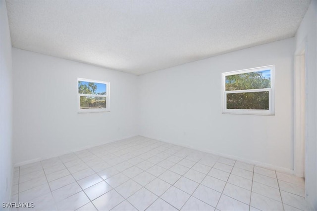 2590 Poinciana St, Naples, FL 34105 - spare room with a wealth of natural light and a textured ceiling