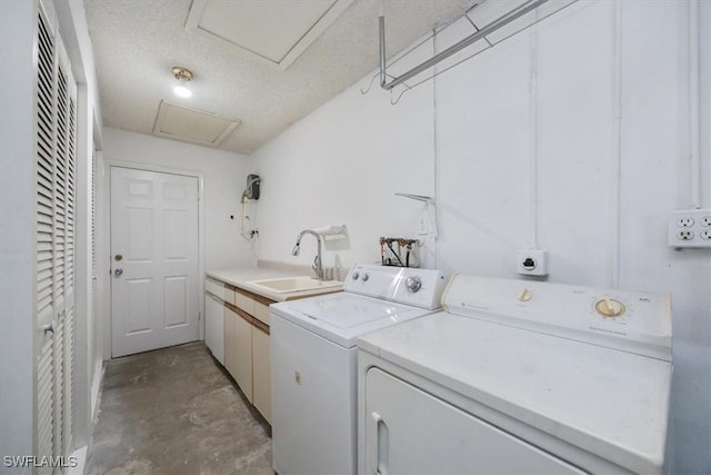 2590 Poinciana St, Naples, FL 34105 - laundry room featuring a textured ceiling, separate washer and dryer, attic access, a sink, and cabinet space