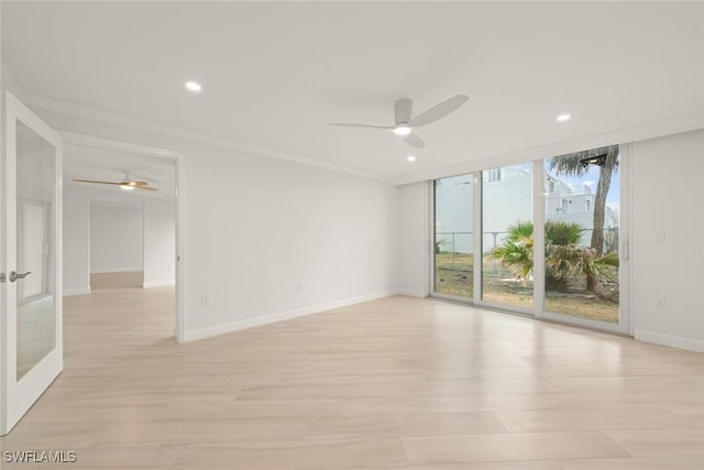 unfurnished room featuring a ceiling fan, light wood-style floors, recessed lighting, baseboards, and floor to ceiling windows