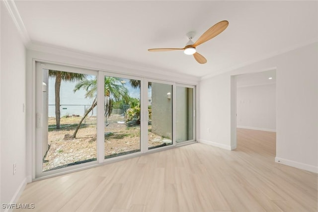 unfurnished room featuring crown molding, ceiling fan, wood finished floors, and baseboards
