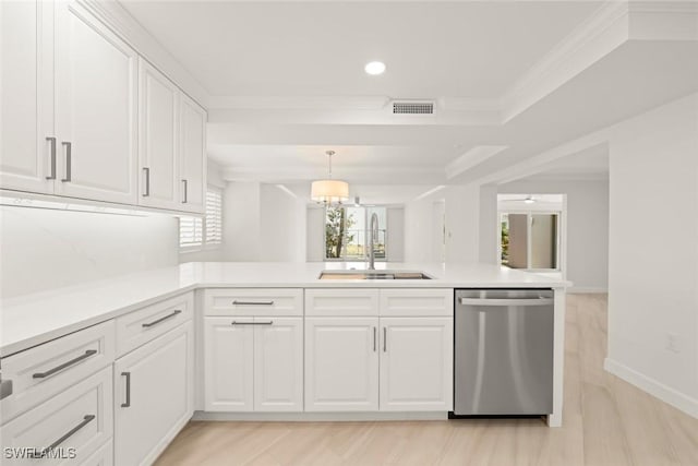 kitchen with stainless steel dishwasher, a sink, white cabinetry, recessed lighting, and crown molding