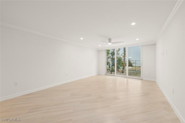 empty room with expansive windows, crown molding, baseboards, recessed lighting, and ceiling fan