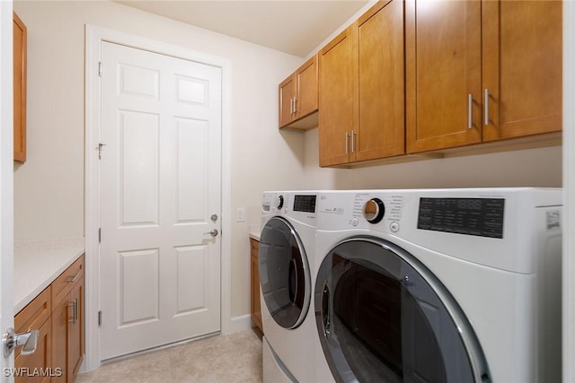 laundry room with separate washer and dryer and cabinet space