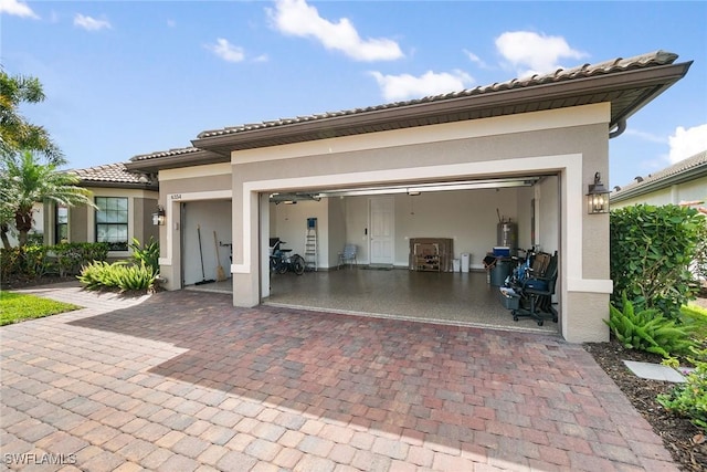 garage with decorative driveway