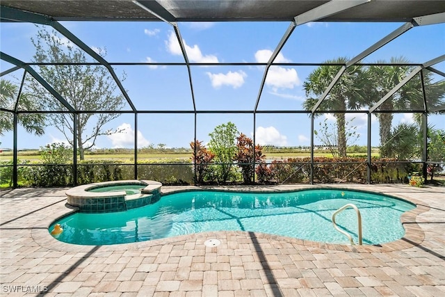 view of swimming pool featuring a pool with connected hot tub, a lanai, and a patio
