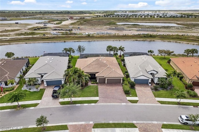 drone / aerial view with a residential view and a water view