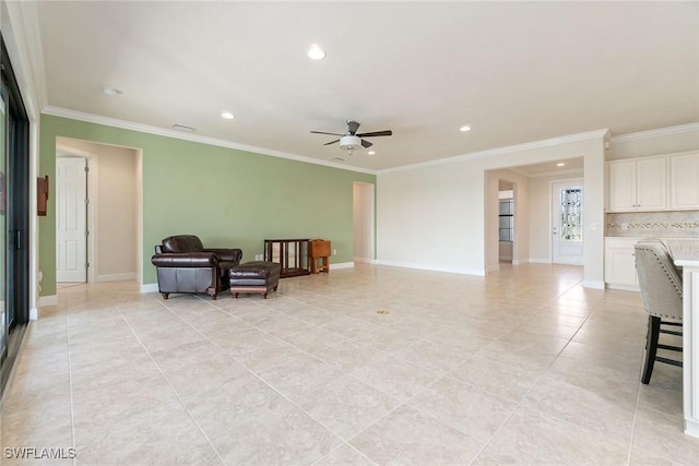 sitting room featuring baseboards, crown molding, recessed lighting, and a ceiling fan