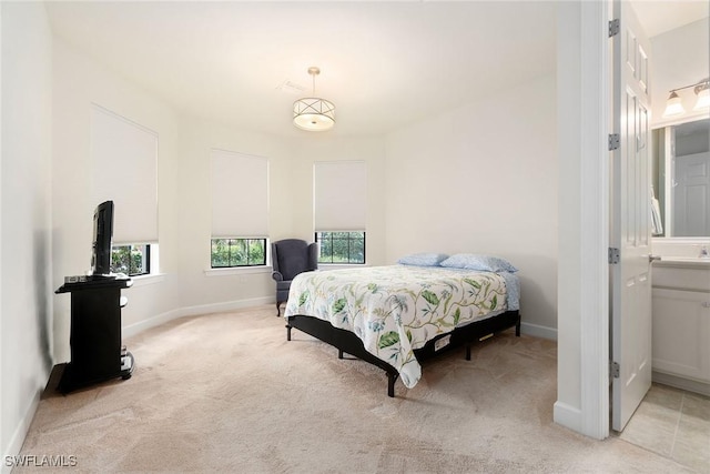 bedroom with light carpet and baseboards