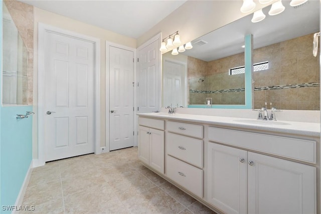 6354 Achievement Ave, Ave Maria, FL 34142 - bathroom with double vanity, a tile shower, tile patterned flooring, and baseboards