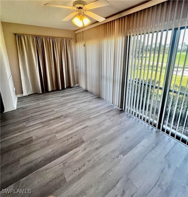 5765 Trailwinds Dr Unit 115, Fort Myers, FL 33907 - unfurnished room featuring a ceiling fan and wood finished floors