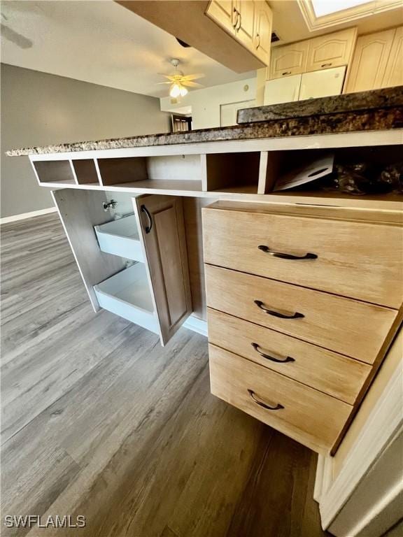 5765 Trailwinds Dr Unit 115, Fort Myers, FL 33907 - kitchen view of dark wood-style flooring, ceiling fan, and baseboards
