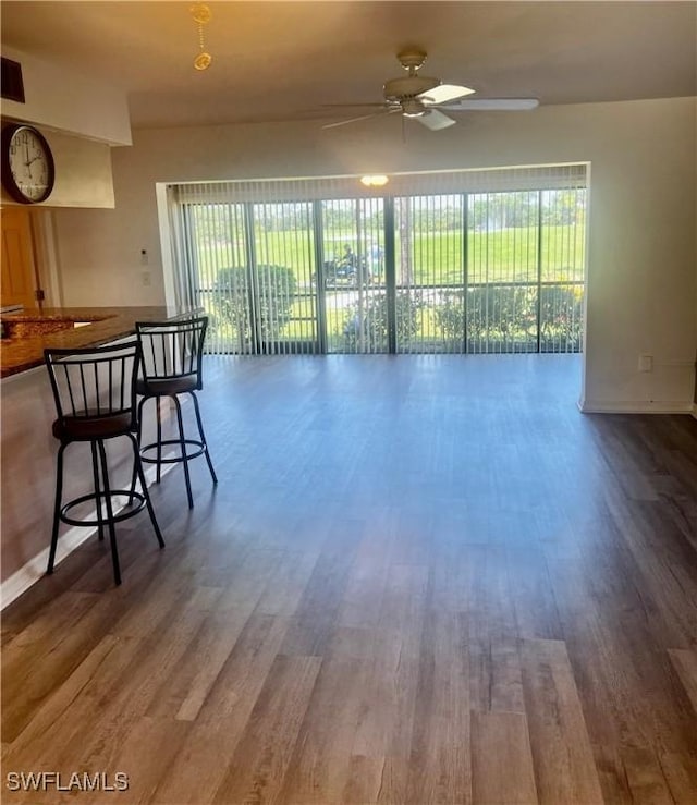 5765 Trailwinds Dr Unit 115, Fort Myers, FL 33907 - living room with plenty of natural light, wood finished floors, a ceiling fan, and baseboards