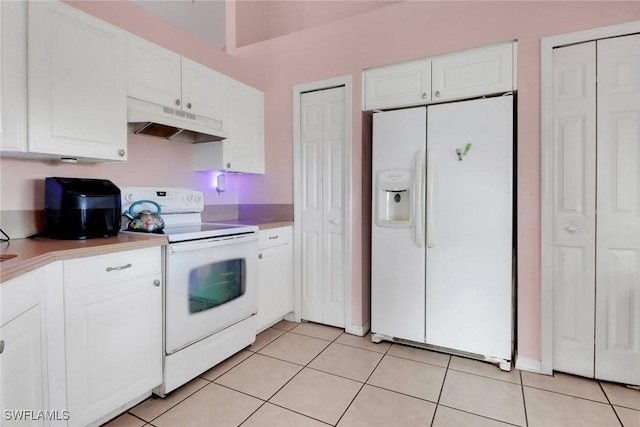 321 NW 19th Ter, Cape Coral, FL 33993 - kitchen featuring white appliances, under cabinet range hood, white cabinetry, and light tile patterned flooring