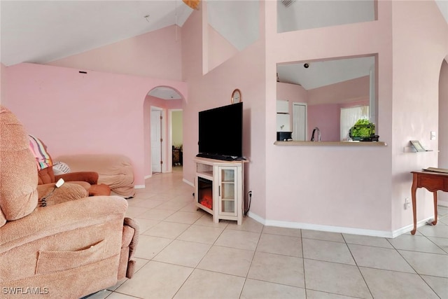 321 NW 19th Ter, Cape Coral, FL 33993 - tiled living room with arched walkways, lofted ceiling, and baseboards