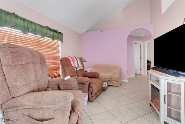 321 NW 19th Ter, Cape Coral, FL 33993 - living room with vaulted ceiling, arched walkways, light tile patterned floors, and baseboards