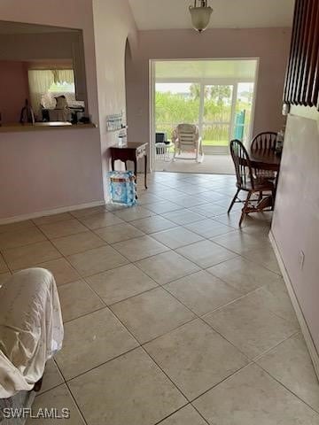 321 NW 19th Ter, Cape Coral, FL 33993 - corridor with light tile patterned flooring, arched walkways, and vaulted ceiling