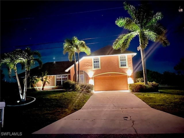 321 NW 19th Ter, Cape Coral, FL 33993 - traditional-style home featuring concrete driveway, an attached garage, stucco siding, and a lawn
