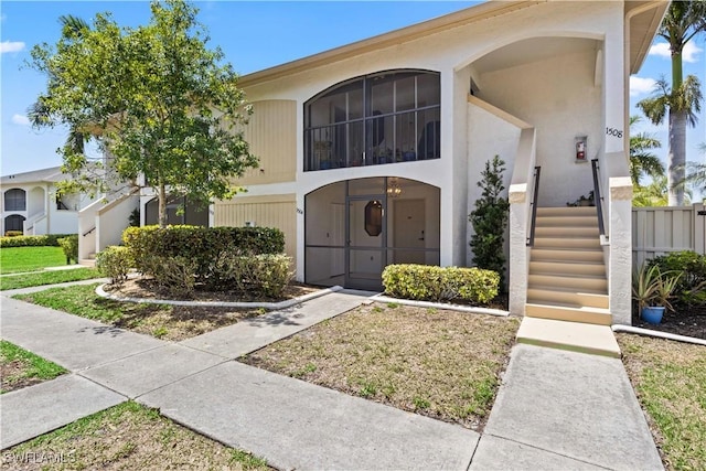 view of front of property with stucco siding and fence
