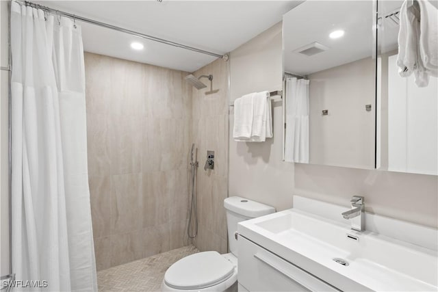 bathroom with visible vents, toilet, a tile shower, recessed lighting, and vanity