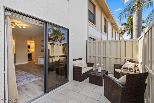 view of patio featuring an outdoor living space and fence