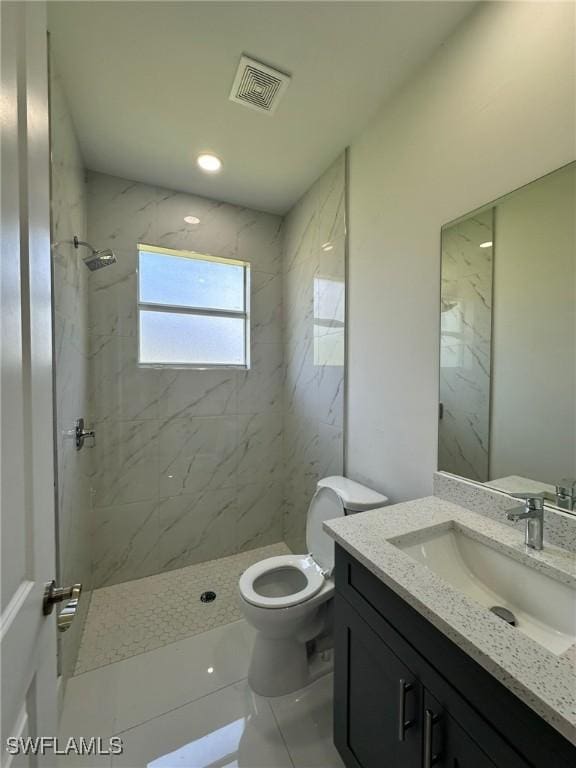 718 Chattman St E, Lehigh Acres, FL 33974 - full bathroom featuring a marble finish shower, vanity, and toilet